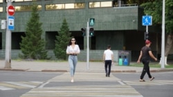Kazakhstan - a woman crossing street. Astana, 17 July 2023