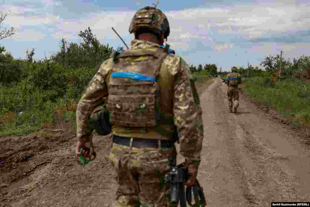 Soldați ucraineni pe un drum în satul eliberat Novodarivka. Satul a fost eliberat la 4 iunie în cadrul contraofensivei Kievului, care a început după ce a acumulat stocuri de arme și muniții occidentale.