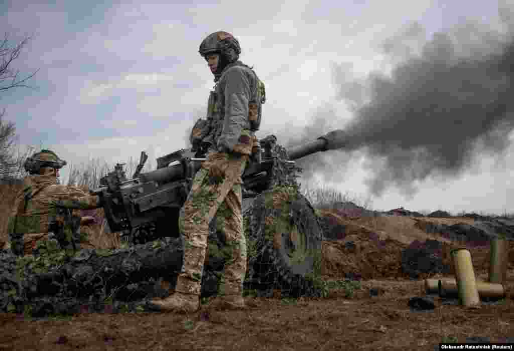Ushtarë ukrainas qëllojnë me një obus M119 në drejtim të pozicioneve ruse.
