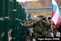 Un rus mobilizat cu un steag rusesc la o secție de mobilizare de la Centrul Internațional de Expoziții Kazan Expo, la 23 octombrie, înainte de a pleca pe front, în Ucraina