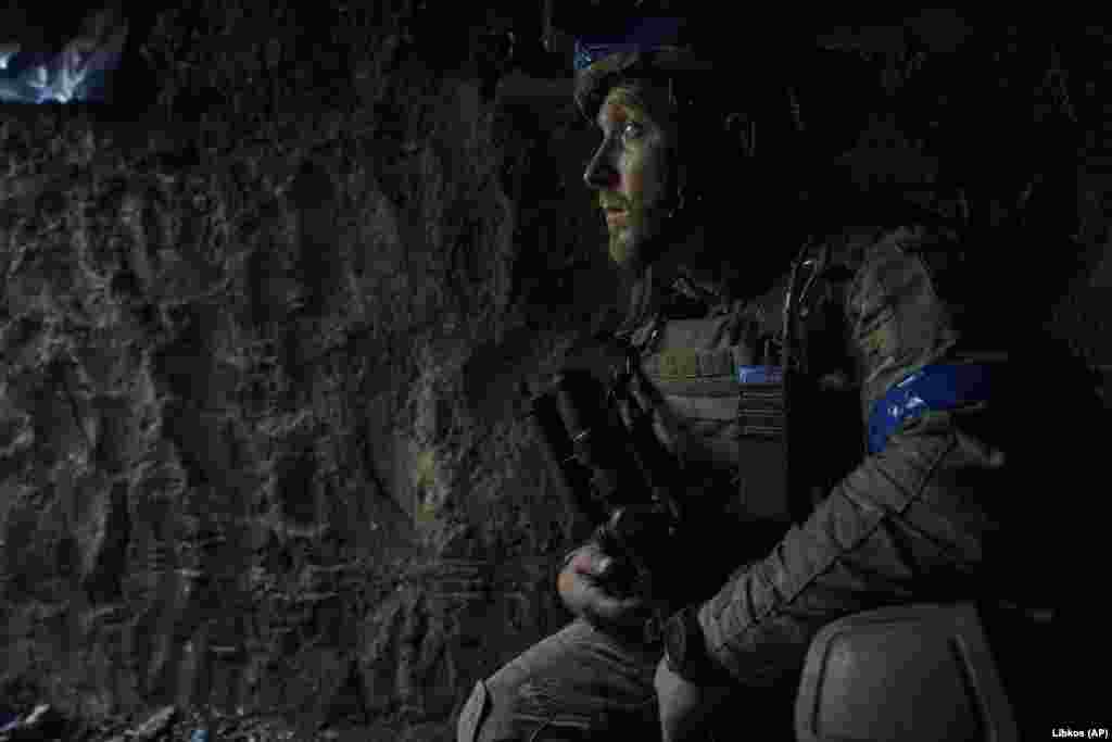 Another soldier looks out of his trench position.&nbsp;