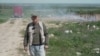 Moldova, Sergiu Fluierar from Crocmaz, Stefan Voda, volunteer ranger inspecting his locality to detect randomly thrown garbage