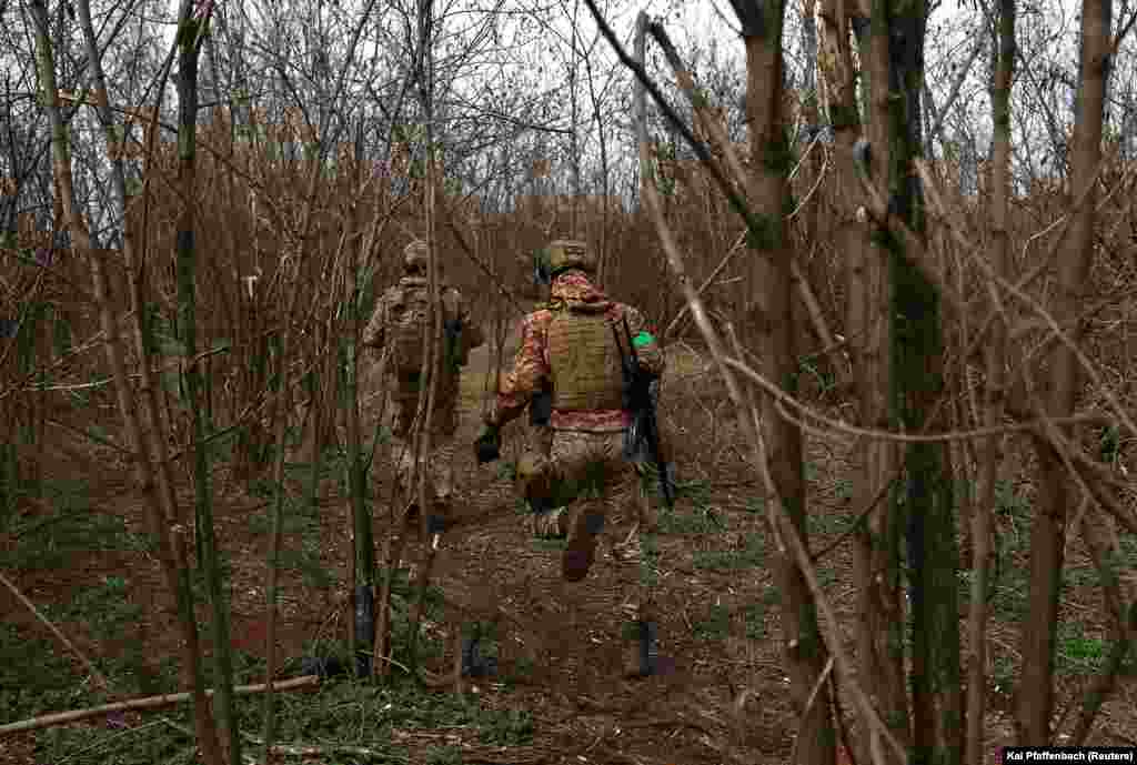 Ukrainian soldiers from the 28th Mechanized Brigade run between positions at the front line. Despite Ukrainian forces being outnumbered, President Volodymyr Zelenskiy said his troops would keep fighting for Bakhmut despite the &quot;very, very difficult&quot; situation there.