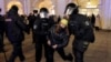 Police officers in St. Petersburg detain an anti-war protester on March 1. 
