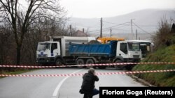 Një gazetar duke fotografuar barrikadën e vendosur në fshatin Rudarë në veri të Kosovës.