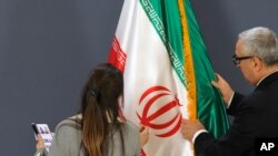 Članovi protokolarnog osoblja nameštaju iransku zastavu pre konferencije za novinare iranskog ministra spoljnih poslova Hoseina Amirabdolahijana sa njegovim srpskim kolegom Ivicom Dačićem u Beogradu, Srbija, 4. decembra 2022. godine.