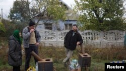 Жители на село в района на Николаев с печки, вода и храна, доставени от доброволци.