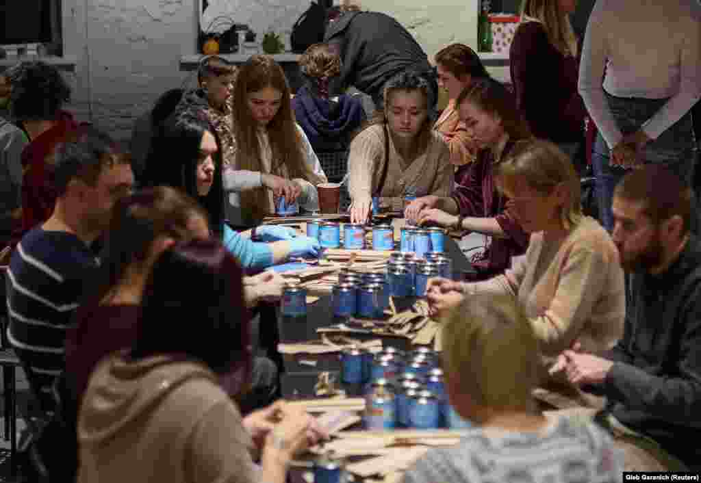 Kyiv locals make candles on October 30 for use in the trenches.