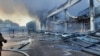 Rescuers work at a site of a shopping mall hit by a Russian missile strike in Kremenchuk on June 27.