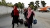 Members of the Afghan robotics girls team arrive to receive their visas from the U.S. embassy in Kabul on July 13.