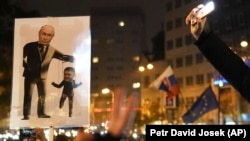 SLOVAKIA – A poster depicting Russian President Vladimir Putin and Slovak Prime Minister Robert Fico (R) at a rally in Bratislava, November 17, 2024