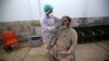A health official conducts a COVID-19 test on a journalist in Peshawar on June 3.