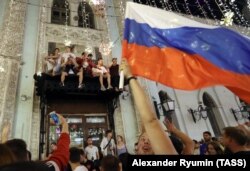 Fans celebrate Russia's victory in the 2018 FIFA World Cup Round of 16 match against Spain in Moscow.