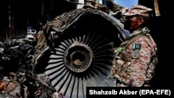 FILE: The wreckage of a state-run Pakistan International Airlines, Airbus A320 lies amid houses days after it crashed in the southern seaport city of Karachi in May 24.