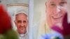 Flowers and portraits of Pope Francis are laid at the statue of John Paul II outside the Gemelli hospital where Pope Francis is hospitalized, in Rome on February 24, 2025.