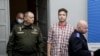 Șeful Aviației și Apărării Aeriene Igor Golub (stânga), activistul Raman Pratasevici (centru) și președintele Comitetului de Investigații din Belarus, Dmitry Gora (dreapta)