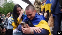 Një ushtar ukrainas flet në telefon me të afërmin e tij pasi kthehet nga robëria gjatë një këmbimi të të burgosurve të luftës midis Rusisë dhe Ukrainës, në rajonin Çernihiv, Ukrainë, 24 maj 2025.