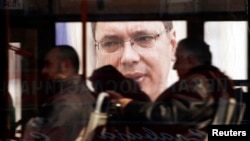 Një autobus kalon pranë një fotografie të Aleksandar Vuçiqit në Beograd...