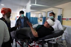 A Sikh woman wounded in the attack is brought to a hospital in Kabul.