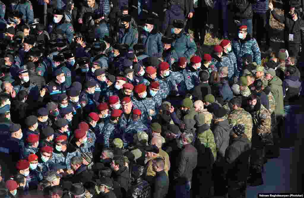 Ерменската полиција е на стража додека Пашинијан оддава почит на воените гробишта на 19 декември.