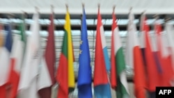 Belgium -- European flags are displayed outside the great hall of the Brussels European Council, 27Jun2012