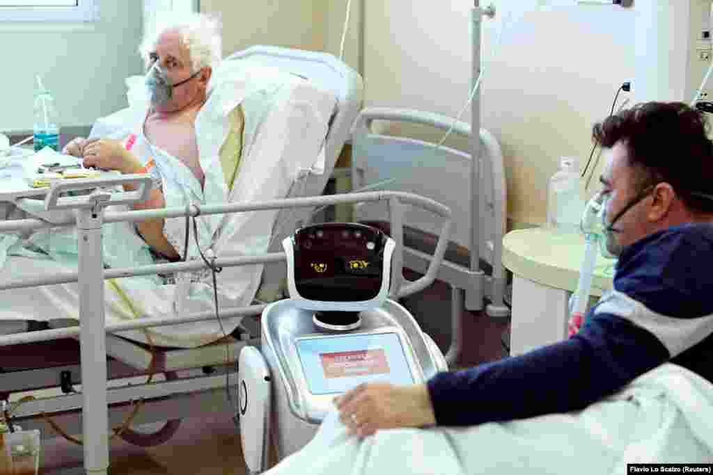 Робот помага на медицински тим при лекување на пациенти заболени од КОВИД-19 во болницата Цирколо, во Варесе, Италија на 1 април. 