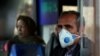 An Iranian man wears a protective masks to prevent contracting coronavirus on a bus in Tehran on February 25.