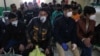 Afghans returning from Iran wait to be screened for the coronavirus on the Islam Qala border crossing in the western province of Herat on March 22.