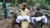 Afghans carry the deceased for a funeral ceremony in Mazar Dara village in the Nurgal district of Kunar Province in eastern Afghanistan on September 1.