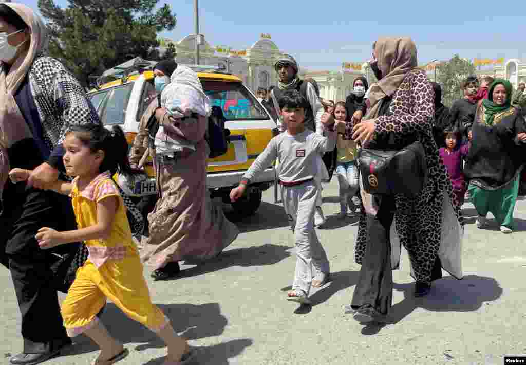 Women with their children try to get inside Hamid Karzai International Airport in Kabul, Afghanistan, on August 16. 