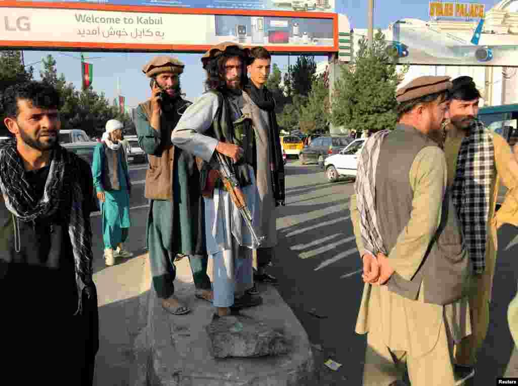 A Taliban fighter keeps watch outside Hamid Karzai International Airport on August 16. 
