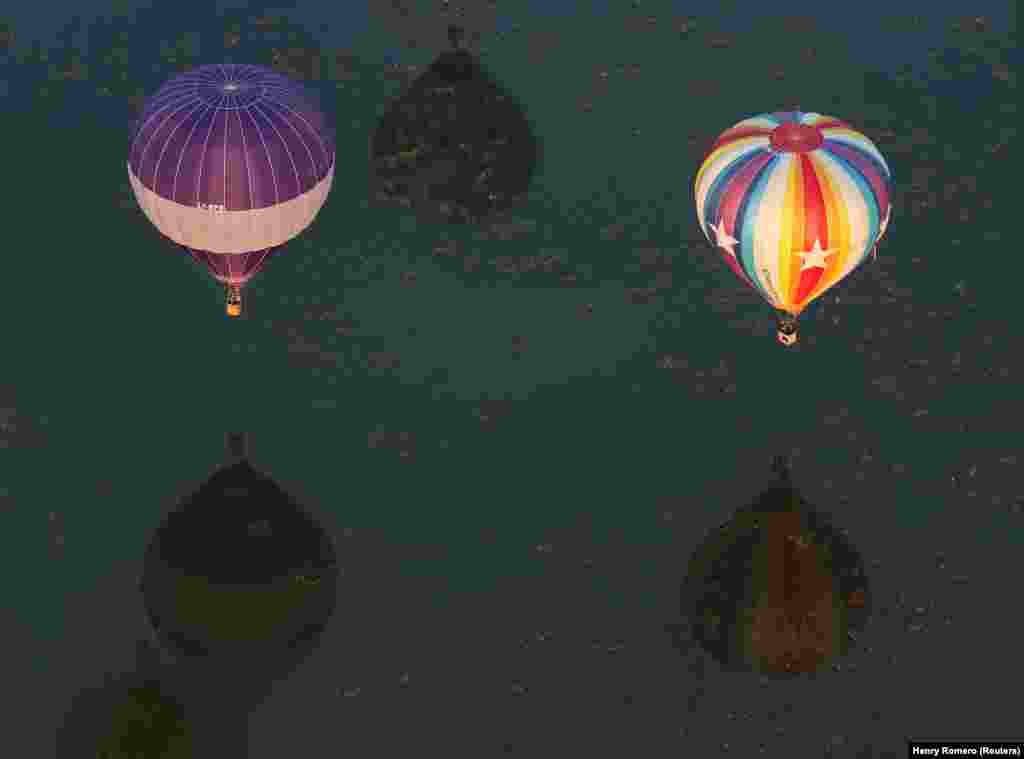 Pasqyrimi i balonave në ujërat e liqenit në parkun Metropolitano. 
