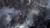 Rescue workers search for the bodies or survivors amid wreckage of a passenger plane of state-run Pakistan International Airlines after it crashed in residential part of Karachi on May 22.