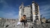 Një djalosh palestinez ulet në gërmadhat e një ndërtese të rrënuar nga lufta në Rripin e Gazës, 9 mars 2024. 