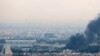 Smoke billows from a site near the Azadi Tower (L) in central Tehran, as fighting between Israel and Iran continues on June 16, 2025.