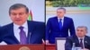 Министр финансов Узбекистана Рустам Азимов (справа) стоя выслушивает критику президента Шавката Мирзияева (слева) в свой адрес. 