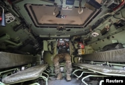 Украински военнослужещ в отделението за войници на брониран автомобил "Брадли" през септември 2023 г.