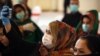 An Afghan girl wearing a face mask 